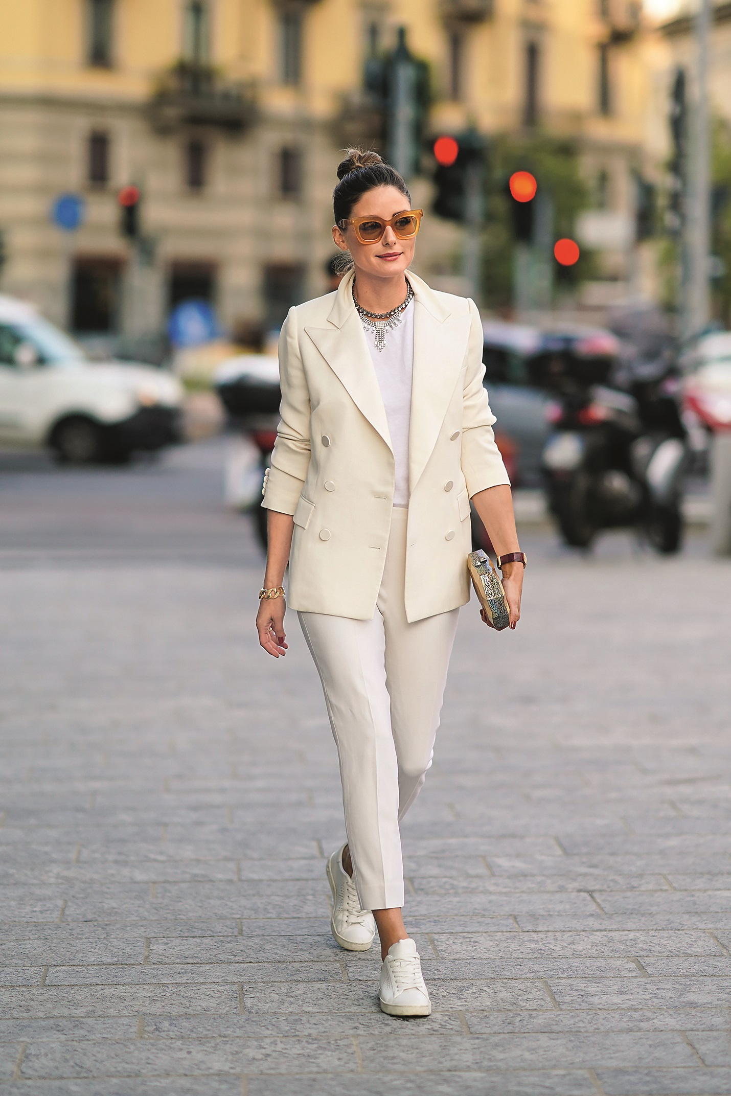 MILAN, ITALY - SEPTEMBER 18: Olivia Palermo wears brown sunglasses, a white blazer jacket, a necklace, a white t-shirt, cropped pants, sneakers, a golden clutch, outside the Alberta Ferretti show during Milan Fashion Week Spring/Summer 2020 on September 18, 2019 in Milan, Italy. (Photo by Edward Berthelot/Getty Images)